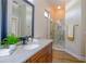 Bathroom with granite countertop vanity, a large walk-in shower, and modern fixtures at 4962 Lazy Oaks Way, St Cloud, FL 34771
