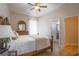 Bright bedroom with a wooden four-poster bed and ensuite bathroom access at 4962 Lazy Oaks Way, St Cloud, FL 34771