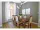 Elegant dining room features a large wood table, six chairs, and a view to the outdoors at 4962 Lazy Oaks Way, St Cloud, FL 34771
