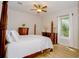 Bedroom with a wooden canopy bed, hardwood floors, and a ceiling fan at 4962 Lazy Oaks Way, St Cloud, FL 34771