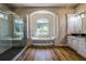 Luxurious bathroom with soaking tub, walk-in shower, and double vanity at 4962 Lazy Oaks Way, St Cloud, FL 34771