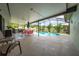 Relaxing pool area with covered patio, outdoor kitchen, and seating at 961 Whisler Ct, St Cloud, FL 34769