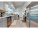 Modern kitchen featuring stainless steel appliances and light gray cabinetry at 961 Whisler Ct, Saint Cloud, FL 34769