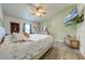 Spacious primary bedroom with large bed, TV, and wood-look floors at 961 Whisler Ct, St Cloud, FL 34769