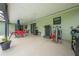 Covered patio with seating area and exercise equipment at 961 Whisler Ct, St Cloud, FL 34769