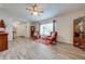 Bright living room with two armchairs and wood-look flooring at 961 Whisler Ct, St Cloud, FL 34769