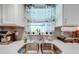 Clean and modern double kitchen sink with white countertop at 961 Whisler Ct, St Cloud, FL 34769