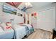 Bright bedroom with twin beds, large TV, and lots of wall decor at 961 Whisler Ct, St Cloud, FL 34769