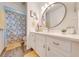 Bright bathroom with a vanity, large mirror, and neutral decor at 961 Whisler Ct, St Cloud, FL 34769