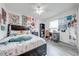 Bedroom with a double bed, built-in desk, and eclectic wall art at 961 Whisler Ct, St Cloud, FL 34769