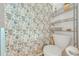 Clean bathroom with toilet, shower, and floral-themed curtain at 961 Whisler Ct, St Cloud, FL 34769