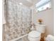 Small bathroom with toilet, shower, and butterfly-themed curtain at 961 Whisler Ct, St Cloud, FL 34769