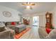 Comfortable living room with sectional sofa, access to patio, and wood floors at 961 Whisler Ct, St Cloud, FL 34769