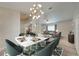 Elegant dining room with marble table and modern chandelier at 961 Whisler Ct, St Cloud, FL 34769