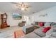 Spacious living room with sectional sofa, large TV, and wood-look floors at 961 Whisler Ct, St Cloud, FL 34769