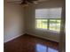 Bright bedroom with wood flooring and large window at 2884 Grasmere View Pkwy, Kissimmee, FL 34746