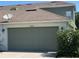 Attached garage with green door and house number at 2884 Grasmere View Pkwy, Kissimmee, FL 34746