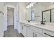 Modern bathroom with double vanity, a large mirror, and a walk-in shower at 4244 Sawtooth Ct, Tavares, FL 32778