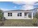Well maintained house exterior with covered patio and AC unit at 4244 Sawtooth Ct, Tavares, FL 32778