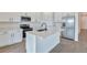 Modern kitchen with white cabinets, stainless steel appliances, and an island at 4244 Sawtooth Ct, Tavares, FL 32778