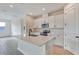 Modern kitchen with white cabinets, island, and stainless steel appliances at 4244 Sawtooth Ct, Tavares, FL 32778