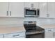 Stainless steel range and microwave in a modern kitchen setting at 4244 Sawtooth Ct, Tavares, FL 32778