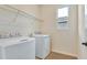 Bright laundry room with shelving and a window at 4244 Sawtooth Ct, Tavares, FL 32778