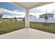 Covered patio overlooking a grassy backyard with new landscaping at 4244 Sawtooth Ct, Tavares, FL 32778