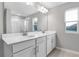 Double vanity bathroom with white cabinets and a shower at 4255 Sawtooth Ct, Tavares, FL 32778