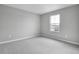 Well-lit bedroom with neutral walls and carpet at 4255 Sawtooth Ct, Tavares, FL 32778