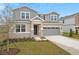 Two-story house with gray siding, stone accents, and a gray garage door at 4255 Sawtooth Ct, Tavares, FL 32778