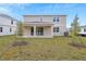 Tan two-story house with covered patio and yard at 4255 Sawtooth Ct, Tavares, FL 32778