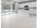 Bright kitchen with white cabinets, an island, and view to backyard at 4255 Sawtooth Ct, Tavares, FL 32778