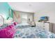 Guest bedroom with twin beds and coastal decor at 880 Pebble Beach Dr, Davenport, FL 33896