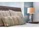Bedroom with wood bed frame, patterned bedding, and decorative pillows at 880 Pebble Beach Dr, Davenport, FL 33896