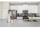 Modern kitchen features stainless steel appliances and ample cabinetry at 880 Pebble Beach Dr, Davenport, FL 33896