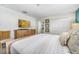 Primary bedroom with TV, dresser and adjacent bathroom at 880 Pebble Beach Dr, Davenport, FL 33896