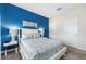Bedroom with white bed frame, blue accent wall, and dresser at 880 Pebble Beach Dr, Davenport, FL 33896