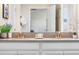 Double vanity bathroom with granite countertops and brushed gold fixtures at 880 Pebble Beach Dr, Davenport, FL 33896