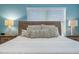 Primary bedroom with wood bed frame and patterned bedding at 880 Pebble Beach Dr, Davenport, FL 33896