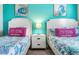 Guest bedroom with twin beds, coastal decor and ocean theme at 880 Pebble Beach Dr, Davenport, FL 33896