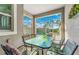 Covered patio with table and chairs, overlooking a pool at 880 Pebble Beach Dr, Davenport, FL 33896