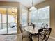 Bright kitchen nook with table and chairs and a view of the pool at 1038 Orange Cosmos Blvd, Davenport, FL 33837