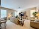 Spacious living room featuring a large entertainment center and comfortable seating at 1038 Orange Cosmos Blvd, Davenport, FL 33837