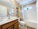 Simple bathroom with a single vanity, toilet, and bathtub at 1038 Orange Cosmos Blvd, Davenport, FL 33837