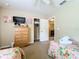 Charming bedroom with two twin beds and a dresser at 1038 Orange Cosmos Blvd, Davenport, FL 33837