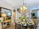 Formal dining room with glass table and comfortable seating at 1038 Orange Cosmos Blvd, Davenport, FL 33837
