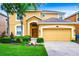 Two-story house with attached garage and manicured lawn at 1038 Orange Cosmos Blvd, Davenport, FL 33837