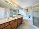 Elegant bathroom with double sinks, soaking tub, and separate shower at 1038 Orange Cosmos Blvd, Davenport, FL 33837