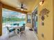 Covered patio with table and chairs, adjacent to the pool at 1038 Orange Cosmos Blvd, Davenport, FL 33837